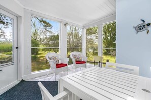 This screened in porch has beautiful views and is the perfect backdrop for your card games or reading a good book