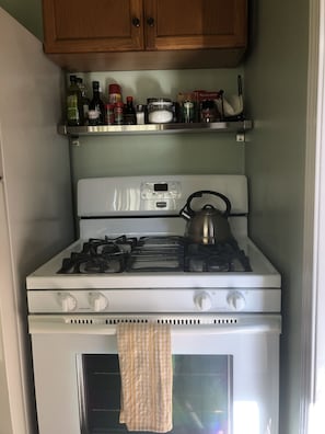 full sized oven with cooking basics stocked for guest use