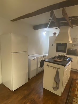 Refridgerator, washing machine, and dryer. Center isle gas stove top