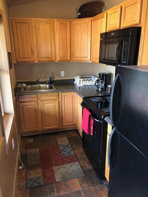 Kitchen with full sized fridge. 