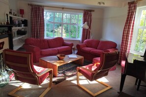 Living room, with baby grand piano just peeking in on the right