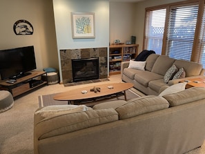 Be at home & relax in our comfortable living room w/ TV, fireplace & couches.