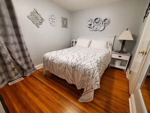 Main floor bedroom offers a queen sized bed with plenty of pillows for a restful nights sleep.