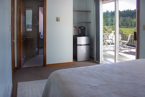 Bedroom with bathroom, deck & hallway access, & mini-fridge w/ freezer & Keurig.