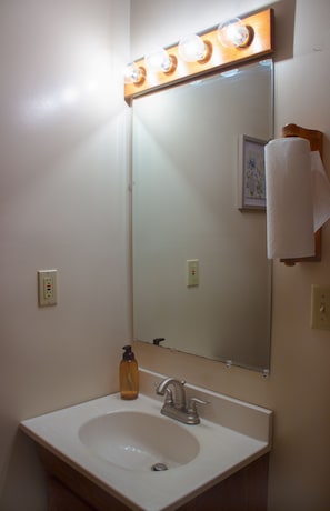 Bathroom with bright vanity lighting.