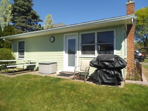 Back side of cottage with barbecue. 