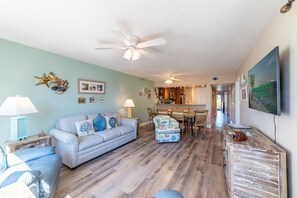 Queen sized sofa sleeper with two leather recliners and decorative "surf" swivel chair