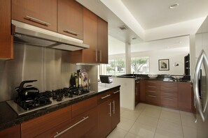 Lovely easy to function kitchen with
chrome backsplash, gas range, microwave,etc
