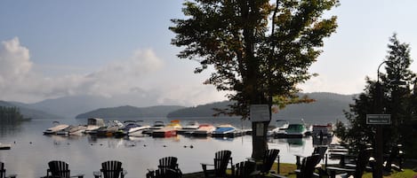 Club marina beach with floating dock, roped off swimming area. Restaurant.