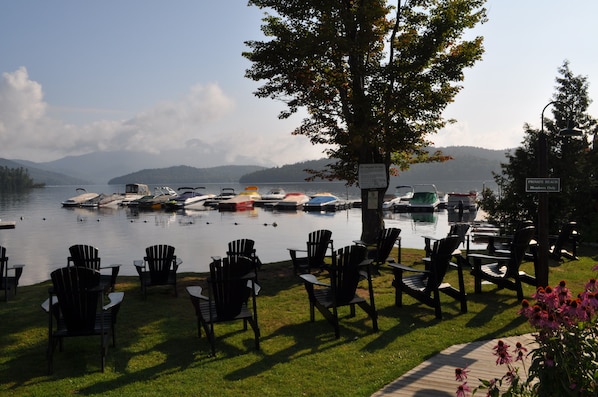 Club marina beach with floating dock, roped off swimming area. Restaurant.