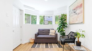 Views of forest and garden in front entrance. Sofa pulls out into a bed for one.