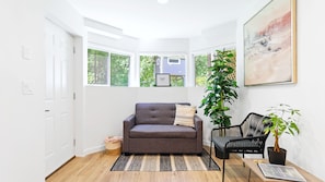 Views of forest and garden in front entrance. Sofa pulls out into a bed for one.