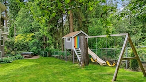 Large yard with treehouse and swings is ideal for families with young children. 