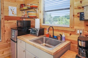 Kitchenette with refrigerator, microwave, toaster oven.