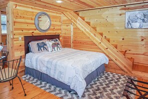 Queen size bed downstairs.  Stairs to the loft behind the bed.