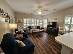 Spacious living room with lots of natural light & views of the golf course! 