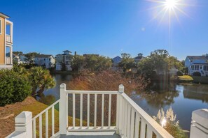 Sit back and watch the birds, alligators, deer and other wildlife that visit the lagoon behind the cottage.