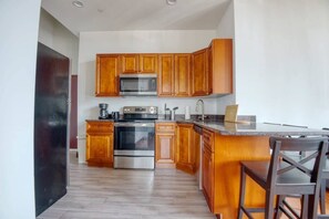 Enjoy home-cooked or the neighborhood's best takeout in this lovely kitchen with stainless steel appliances, a microwave, and a full-sized refrigerator