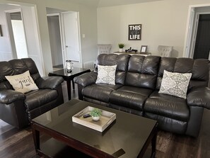 Unwind & catch up on your favorite shows on the 43” TV in this cozy living room.