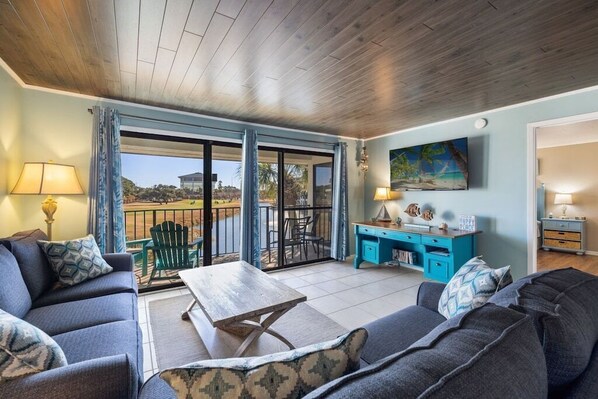 View of den with couch and loveseat and flat screen television