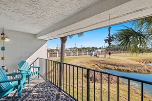 View of balcony overlooking 6th tee of 9 hole golf course.