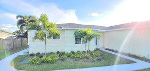 Coastal Apartment has lighted walkway entrance from driveway.