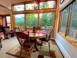 The open-concept living room/dining room/kitchen has a wood-burning fireplace that adds ambiance on those cold nights