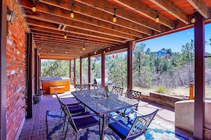 Outdoor dining with grill and hot tub.