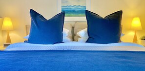 Cozy crisp King Bed with plush mattress and soft cotton linens.