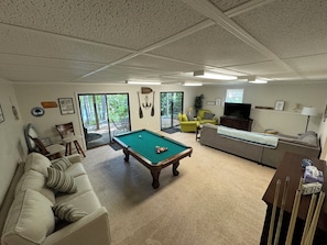 HUGE rec room with pool table, sitting area, and 60" TV.