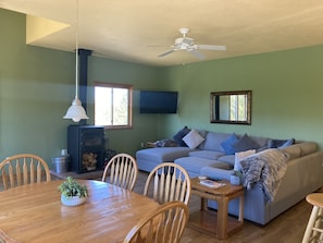 Living rm w/ wood burning stove. 50” HDTV w/complementary Netflix Hulu & Amazon