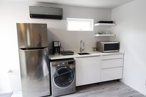 Kitchen with an LG microwave, One burner induction cooktop and coffee maker. 