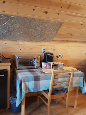 Table and chairs for two. Keurig and toaster oven. Infrared plate and fridge.