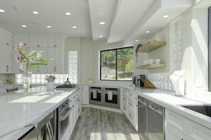 A chef's delight.  A large gourmet kitchen with double ovens, double dishwashers and more.
