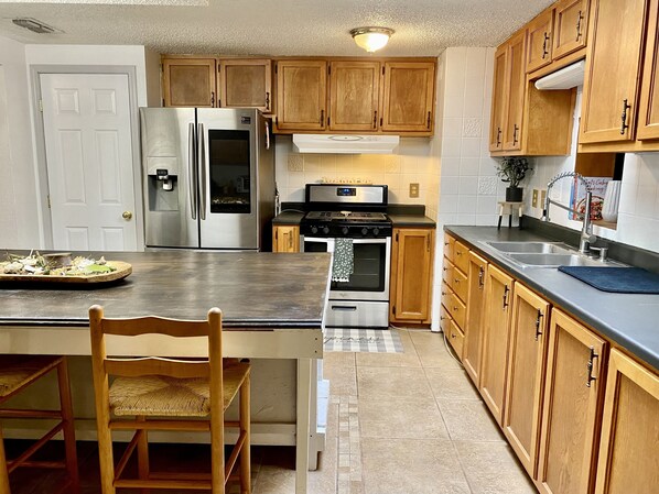 [Kitchen] Play music on the Amazon Dot. The living area is to the right.