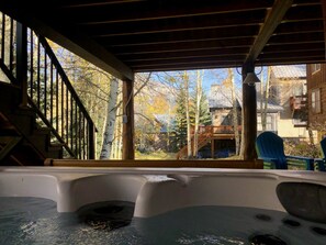 Covered outdoor living space with hot tub view of Mt. Crested Butte