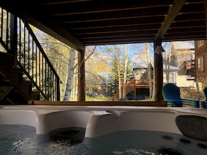 Covered outdoor living space with hot tub view of Mt. Crested Butte
