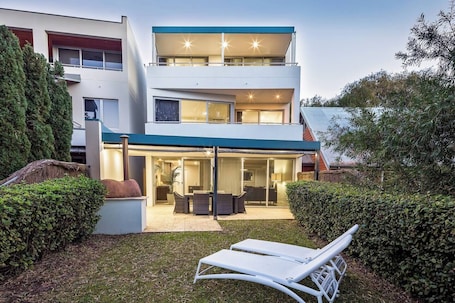 Soak up the sun from the garden loungers as the kids enjoy playing on the grassy yard.