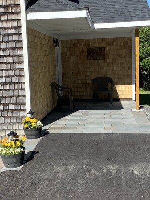 Patio entrance to main living area, 4 car driveway.