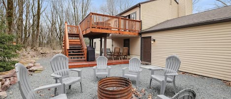 Daytime photo of fire pit and back yard area.  