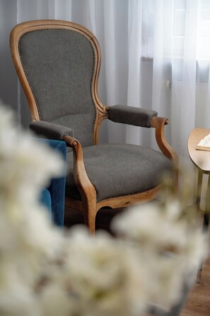 Close-up of vintage-style armchair and flowers – Adds a touch of charm and character to the living space.
