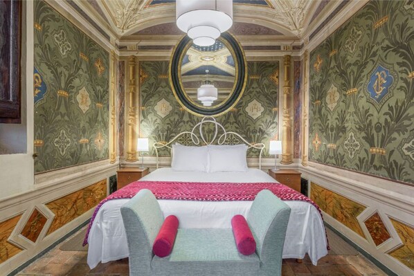 Wake up under a frescoed ceiling in a bedroom that marries historic artistry with contemporary comfort.