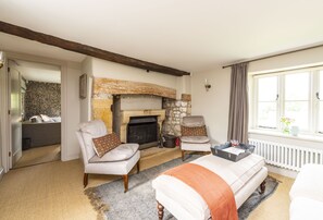 Manor Farmhouse, Cruxton: Sitting room with open fire