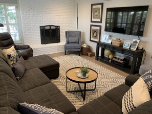 living room with smart tv and fireplace