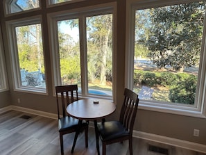 Bistro table in family room overlooking the pool and golf course