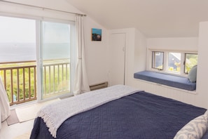 Primary bedroom with closets and window seat, all with gorgeous ocean views.