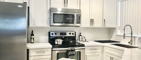 New white updated kitchen with quartz counter tops Great Lighting