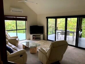 Living room with recliner lounge and chars and smart TV