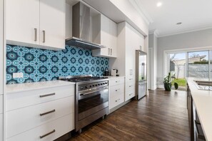 Kitchen with 900mm Gas cooktop, electric oven, dishwasher, coffee pod machine & large island bench.