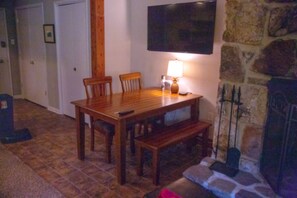 Dining table has two chairs and a bench.